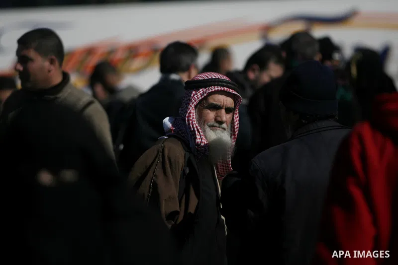 Palestinian families wait at the the Rafah border crossing between Egypt and the southern Gaza Strip on January 8, 2014. Egyptian authorities partially opened Rafah Crossing, Gaza's main window to the world, for two days...