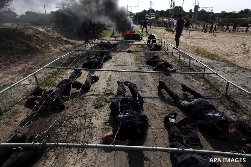 Palestinian high school students take part in a military-styled exercise routine at a course conducted by the Hamas-run ministry of education, in Rafah in the southern Gaza Strip January 9, 2014. Male students would lear...
