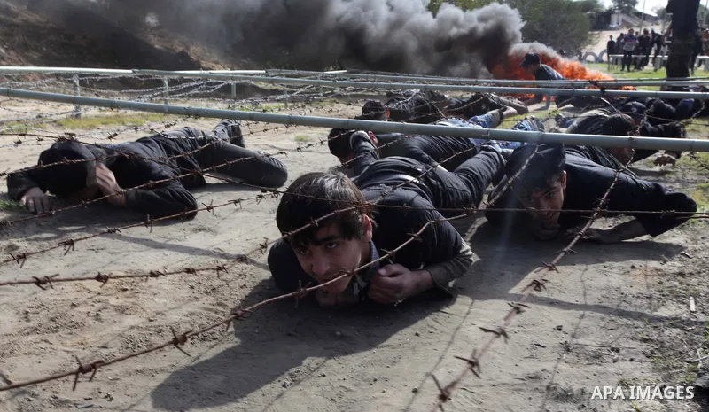 Palestinian high school students take part in a military-styled exercise routine at a course conducted by the Hamas-run ministry of education, in Rafah in the southern Gaza Strip January 9, 2014. Male students would lear...