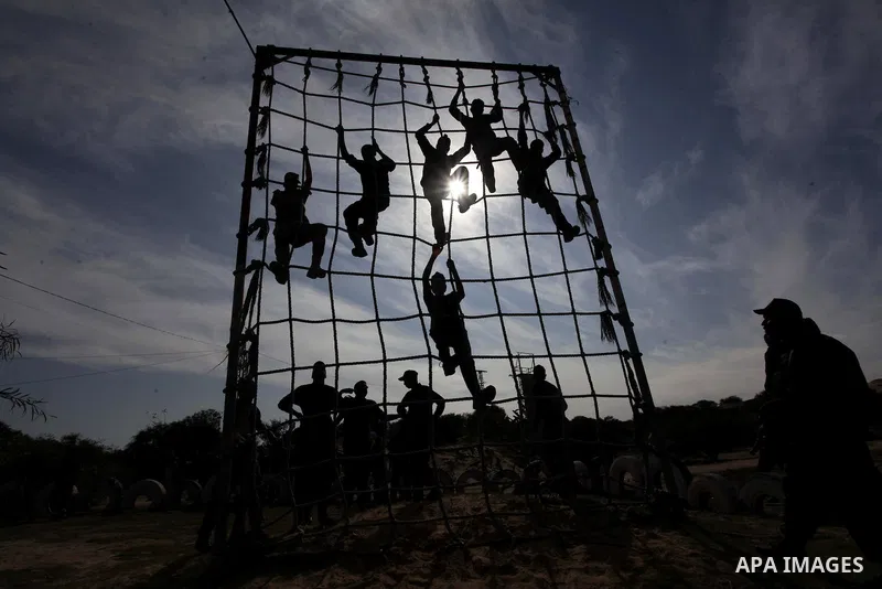 Palestinian high school students take part in a military-styled exercise routine at a course conducted by the Hamas-run ministry of education, in Rafah in the southern Gaza Strip January 9, 2014. Male students would lear...