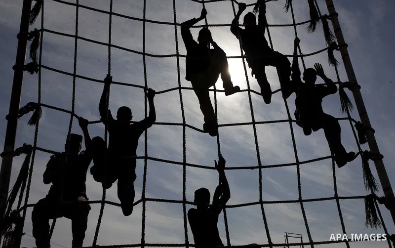 Palestinian high school students take part in a military-styled exercise routine at a course conducted by the Hamas-run ministry of education, in Rafah in the southern Gaza Strip January 9, 2014. Male students would lear...