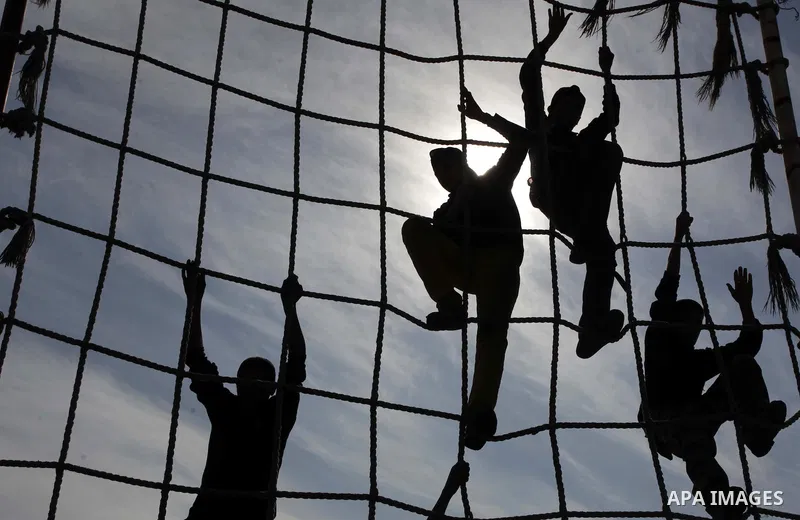 Palestinian high school students take part in a military-styled exercise routine at a course conducted by the Hamas-run ministry of education, in Rafah in the southern Gaza Strip January 9, 2014. Male students would lear...