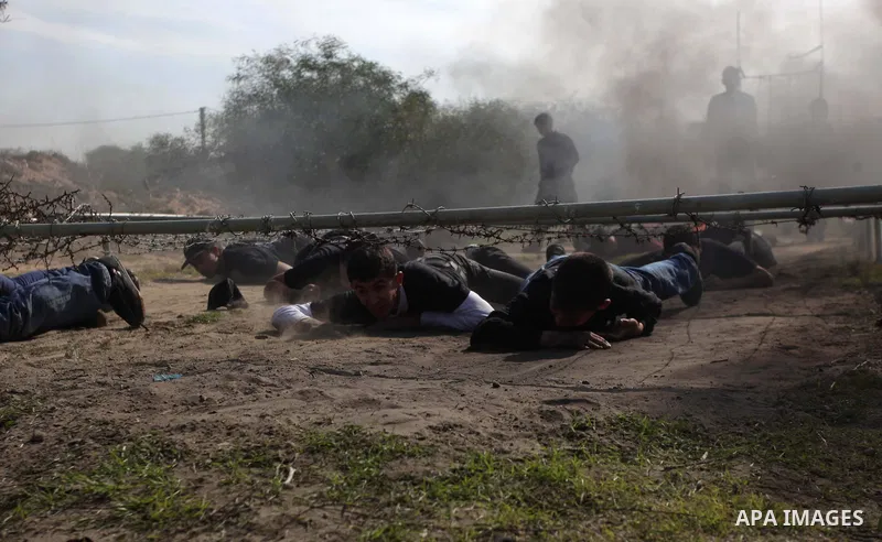 Palestinian high school students take part in a military-styled exercise routine at a course conducted by the Hamas-run ministry of education, in Rafah in the southern Gaza Strip January 9, 2014. Male students would lear...