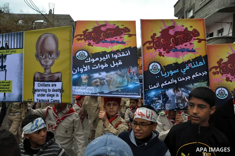 Palestinian boys take part in a rally to show solidarity with Palestinian refugees in Syria's main refugee camp Yarmouk, in Jabalia in the northern Gaza Strip January 10, 2014. Photo by Mohammed Talatene