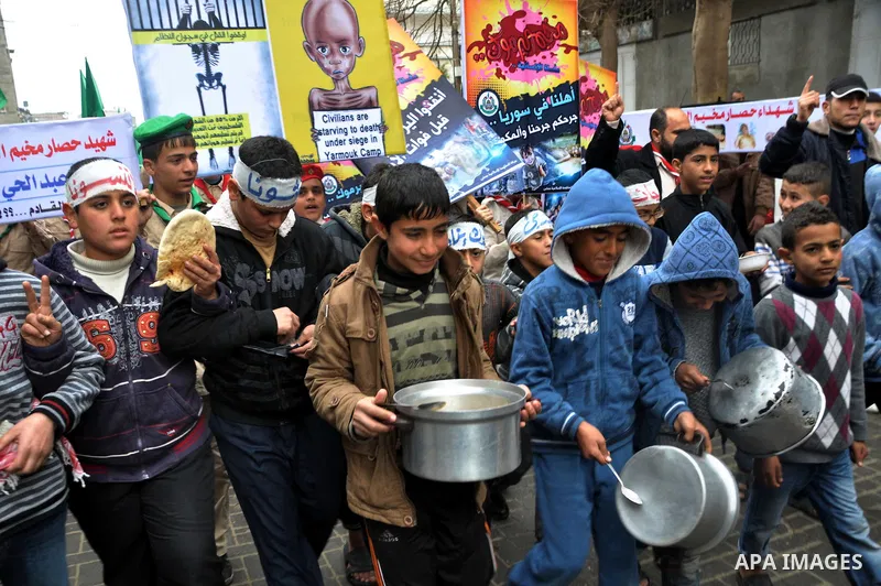 Palestinian boys take part in a rally to show solidarity with Palestinian refugees in Syria's main refugee camp Yarmouk, in Jabalia in the northern Gaza Strip January 10, 2014. Photo by Mohammed Talatene