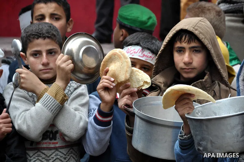 Palestinian boys take part in a rally to show solidarity with Palestinian refugees in Syria's main refugee camp Yarmouk, in Jabalia in the northern Gaza Strip January 10, 2014. Photo by Mohammed Talatene