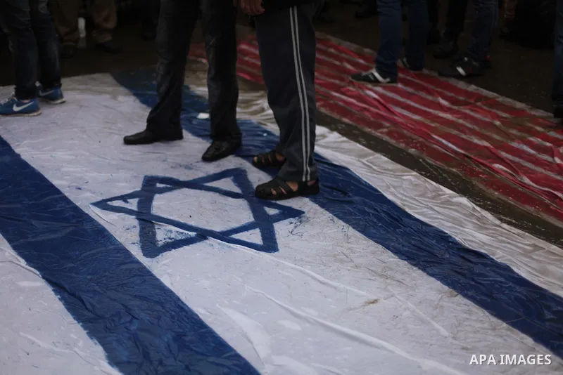 Palestinian supporters of the Islamic Jihad step on a representation of the Israeli flag as they demonstrate against resuming peace talks with Israel in Gaza City, Jan. 10, 2014. In recent weeks, U.S. Secretary of State...