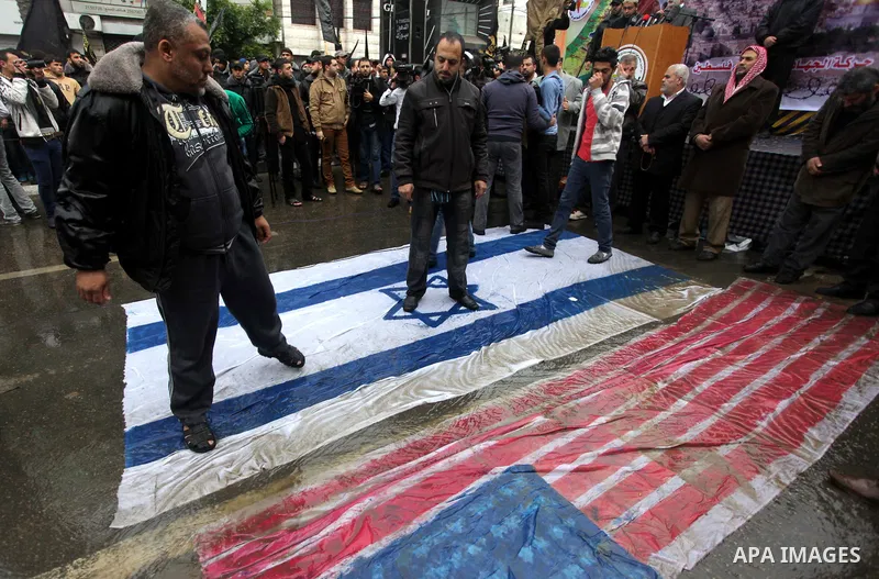 Palestinian supporters of the Islamic Jihad step on a representation of the Israeli flag as they demonstrate against resuming peace talks with Israel in Gaza City, Jan. 10, 2014. In recent weeks, U.S. Secretary of State...