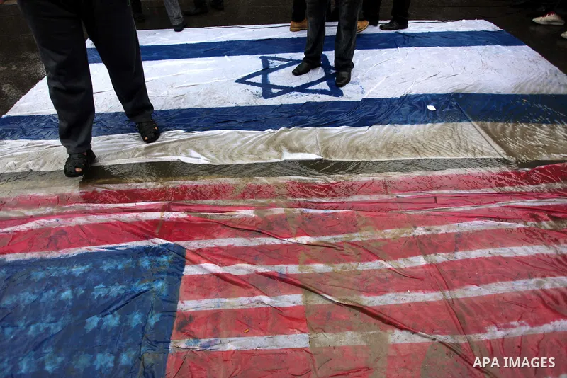 Palestinian supporters of the Islamic Jihad step on a representation of the Israeli flag as they demonstrate against resuming peace talks with Israel in Gaza City, Jan. 10, 2014. In recent weeks, U.S. Secretary of State...