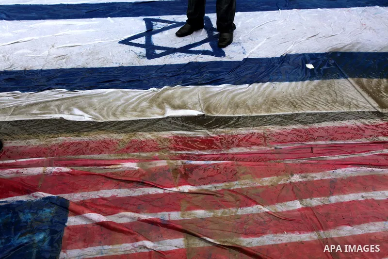 Palestinian supporters of the Islamic Jihad step on a representation of the Israeli flag as they demonstrate against resuming peace talks with Israel in Gaza City, Jan. 10, 2014. In recent weeks, U.S. Secretary of State...