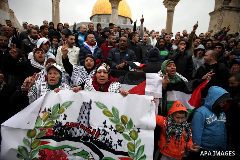 Palestinian worshipers hold placards and chant slogans during a protest calling for the end of the political division between the Gaza Strip Hamas-led leadership and the Palestinian Authority Fatah-led, and in solidarity...