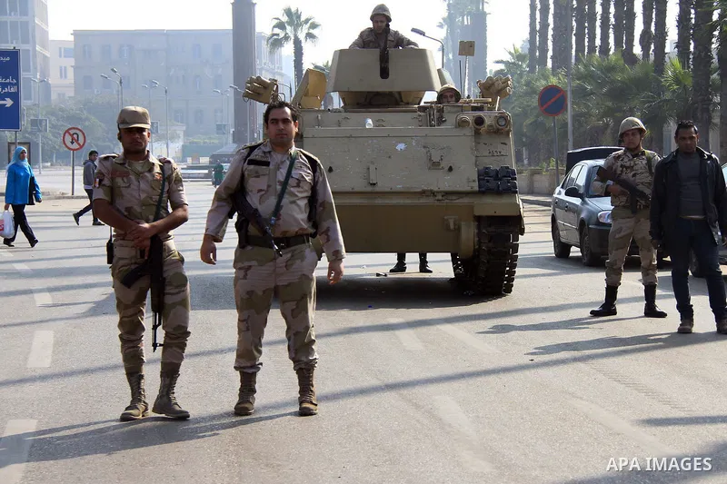 Egyptian security forces take position as students of Cairo University, who are supporters of the Muslim Brotherhood and deposed Egyptian President Mohamed Mursi protest in Cairo on January 10, 2014. The group's backers...