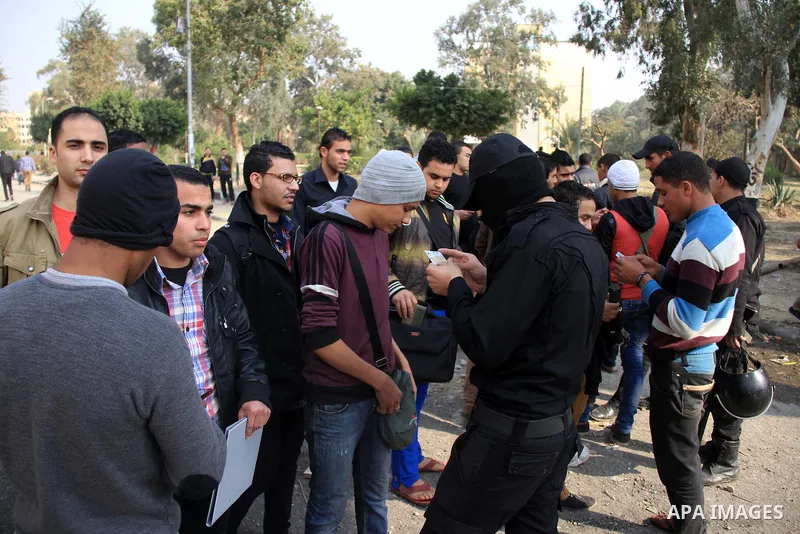 Egyptian security forces check students of al-Azhar University outside their residential area, in Cairo, January 12, 2013. Reports state that three years after the Arab Spring, pro-military groups and old regime stalwart...