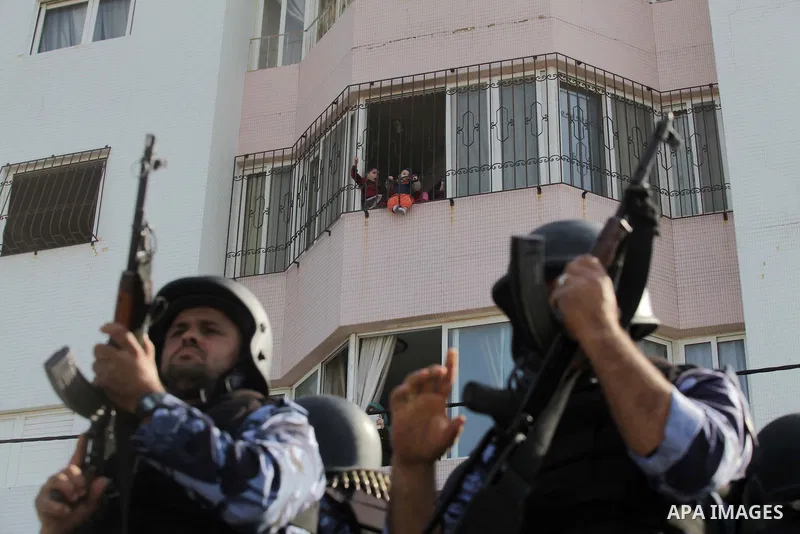 Palestinian security forces show their skills during a military parade in Gaza city on January 13, 2014, marking the fifth anniversary of the three-week Israeli offensive on the Gaza Strip in which more than a thousand P...
