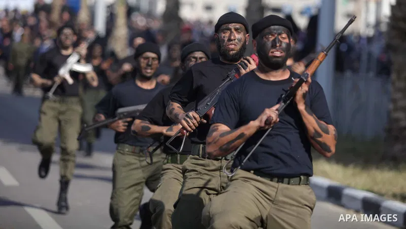 Palestinian security forces show their skills during a military parade in Gaza city on January 13, 2014, marking the fifth anniversary of the three-week Israeli offensive on the Gaza Strip in which more than a thousand P...
