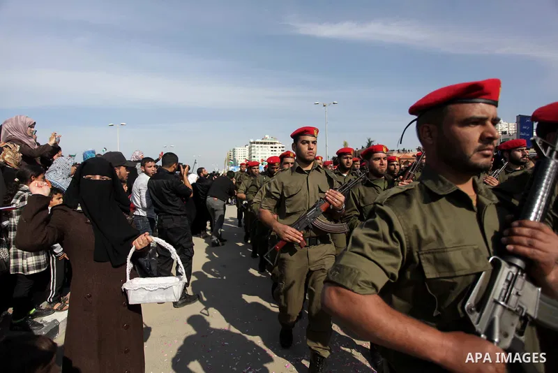 Palestinian security forces show their skills during a military parade in Gaza city on January 13, 2014, marking the fifth anniversary of the three-week Israeli offensive on the Gaza Strip in which more than a thousand P...
