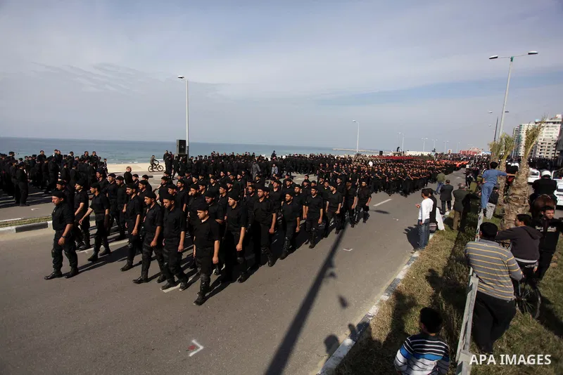 Palestinian security forces show their skills during a military parade in Gaza city on January 13, 2014, marking the fifth anniversary of the three-week Israeli offensive on the Gaza Strip in which more than a thousand P...