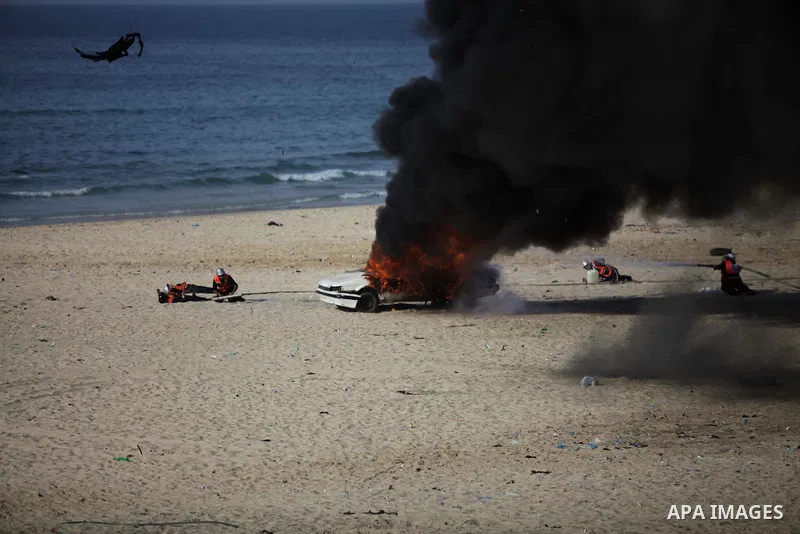 Palestinian civil defense show their skills during a military parade in Gaza city on January 13, 2014, marking the fifth anniversary of the three-week Israeli offensive on the Gaza Strip in which more than a thousand Pal...