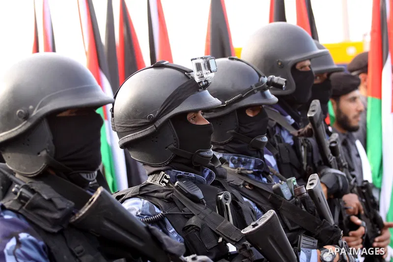 Palestinian security forces show their skills during a military parade in Gaza city on January 13, 2014, marking the fifth anniversary of the three-week Israeli offensive on the Gaza Strip in which more than a thousand P...