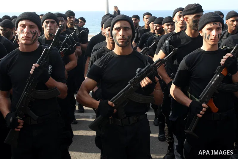 Palestinian security forces show their skills during a military parade in Gaza city on January 13, 2014, marking the fifth anniversary of the three-week Israeli offensive on the Gaza Strip in which more than a thousand P...