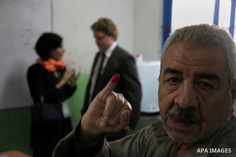 An Egyptian proudly shows his ink marked finger after he voted during the referendum on the draft constitution, at a polling station in Cairo, Egypt, 14 January 2014. Egyptians began on 14 January to vote on a new consti...