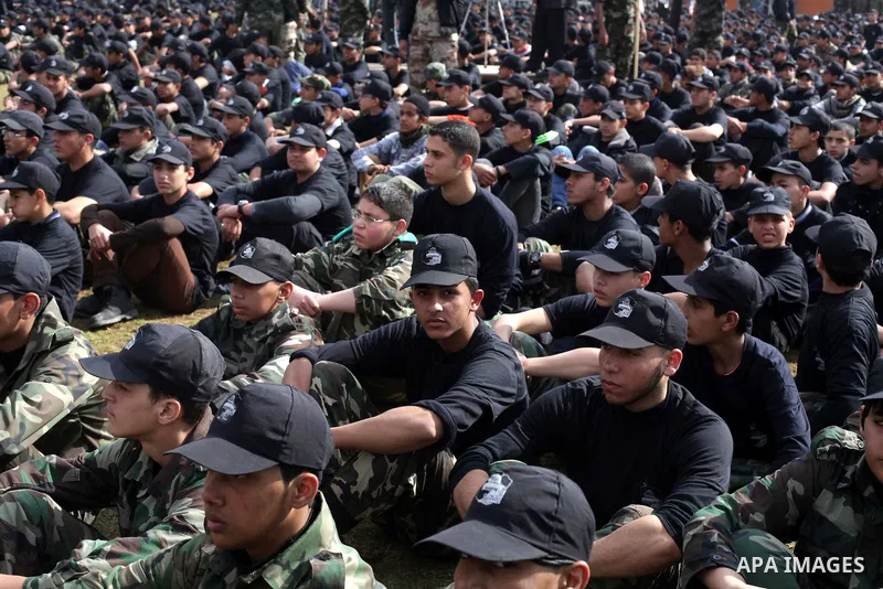 Palestinian students take part in a graduation ceremony for a military-style training programme in Gaza City on January 14, 2014. Some 13,000 students joined the course, which is aimed at preparing them for "liberating P...
