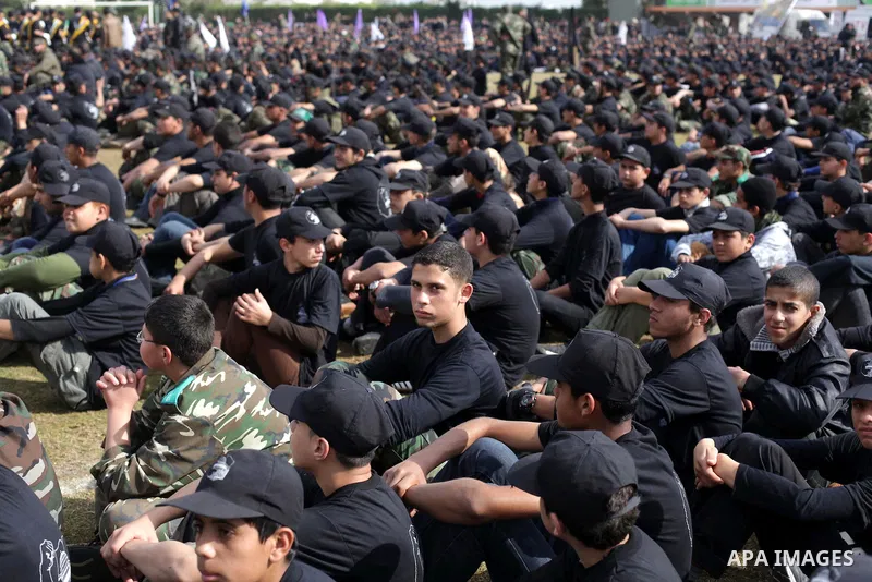 Palestinian students take part in a graduation ceremony for a military-style training programme in Gaza City on January 14, 2014. Some 13,000 students joined the course, which is aimed at preparing them for "liberating P...