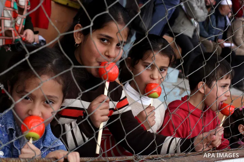 Palestinians attend a graduation ceremony for a military-style training programme in Gaza City on January 14, 2014. Some 13,000 students joined the course, which is aimed at preparing them for "liberating Palestine from...