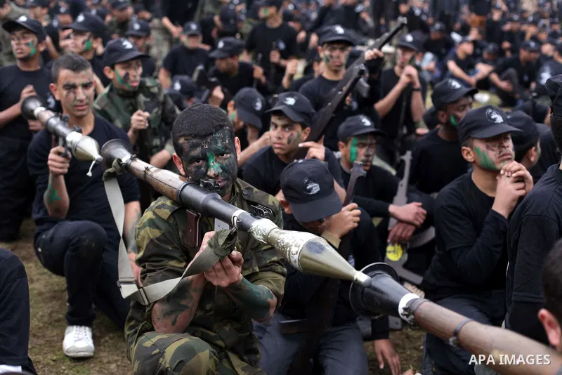 Palestinian students take part in a graduation ceremony for a military-style training programme in Gaza City on January 14, 2014. Some 13,000 students joined the course, which is aimed at preparing them for "liberating P...