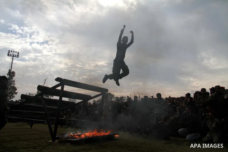 Palestinian students take part in a graduation ceremony for a military-style training programme in Gaza City on January 14, 2014. Some 13,000 students joined the course, which is aimed at preparing them for "liberating P...