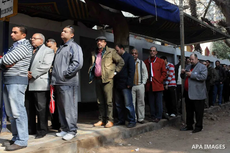 Egyptian queue up at a polling station during the second day of voting on a new constitution on January 15, 2014 in Cairo. Egyptians resumed voting in the constitutional referendum, with turnout expected to hold the key...