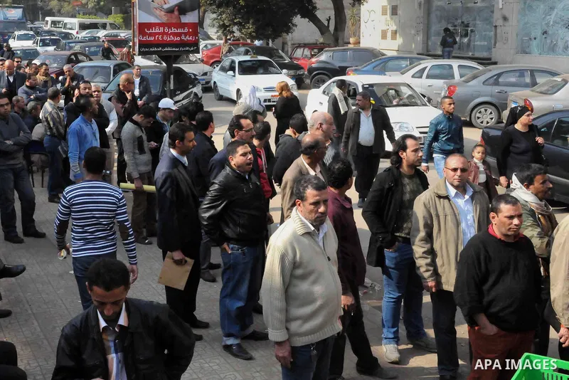 Egyptian queue up at a polling station during the second day of voting on a new constitution on January 15, 2014 in Cairo. Egyptians resumed voting in the constitutional referendum, with turnout expected to hold the key...