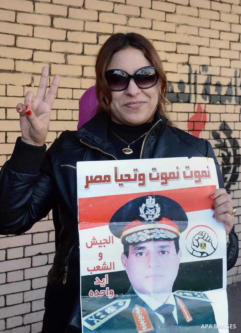 An Egyptian voter inks her finger after casting her ballot in a two-day constitutional referendum in Cairo, Egypt, Wednesday, Jan. 15, 2014. Egyptians voted on the second, final day of a key referendum on a new constitut...
