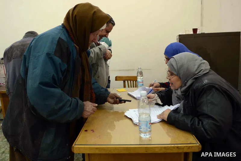 Egyptians cast their ballot at a polling station during the second day of voting on a new constitution on January 15, 2014 in the Nasr City district of the Egyptian capital, Cairo. Egyptians resumed voting in the constit...