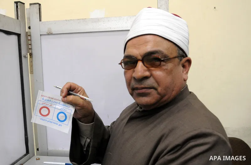 Egyptians cast their votes during the second day of voting on a new constitution on January 15, 2014 in Cairo. Egyptians resumed voting in the constitutional referendum, with turnout expected to hold the key to a likely...