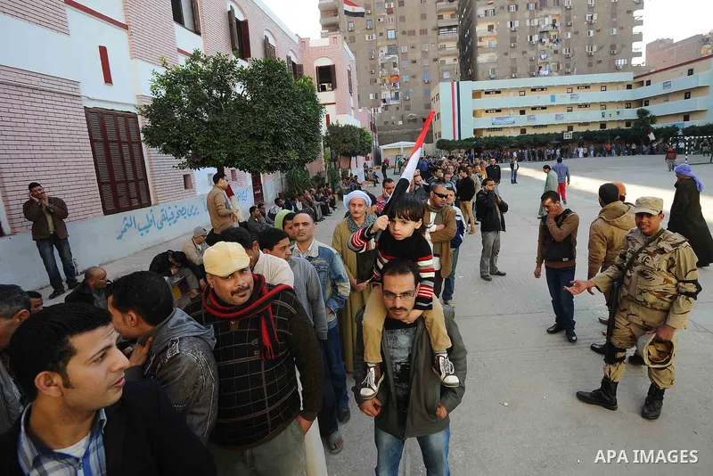 Egyptians cast their votes during the second day of voting on a new constitution on January 15, 2014 in Cairo. Egyptians resumed voting in the constitutional referendum, with turnout expected to hold the key to a likely...