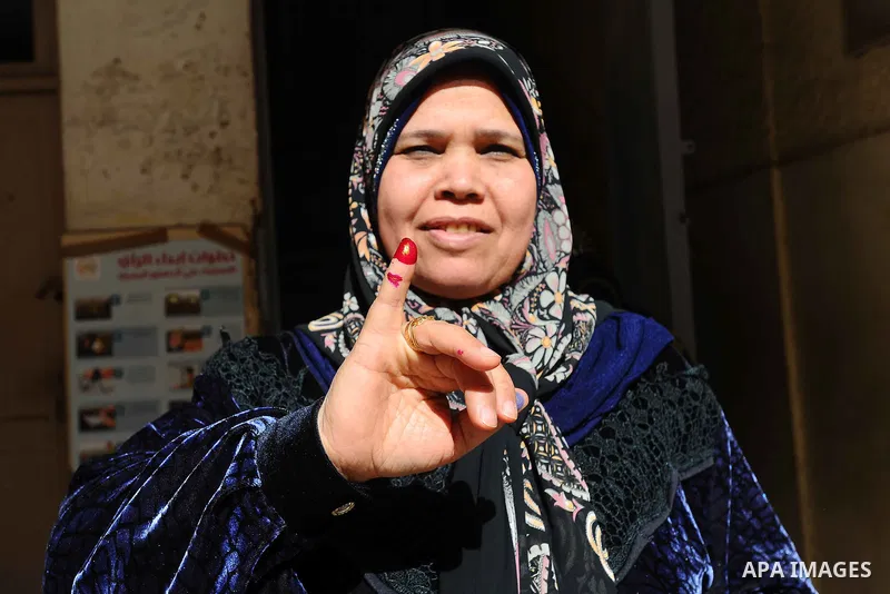 Egyptians cast their votes during the second day of voting on a new constitution on January 15, 2014 in Cairo. Egyptians resumed voting in the constitutional referendum, with turnout expected to hold the key to a likely...