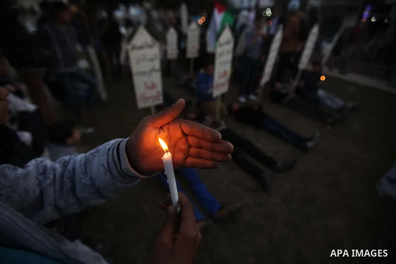 Palestinian children hold placards as they take part in a rally to show solidarity with Palestinian refugees in Syria's main refugee camp Yarmouk, in Deir al-Balah in the central Gaza Strip January 15, 2014. Photo by Ash...