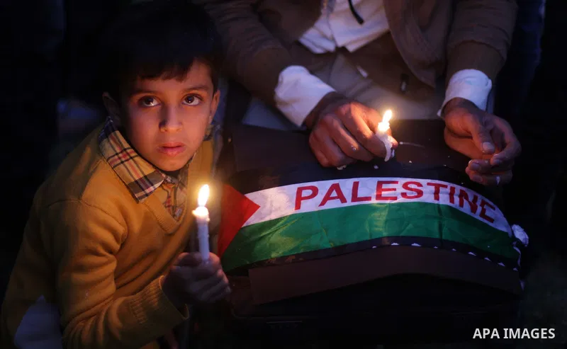 Palestinian children hold candles as they take part in a rally to show solidarity with Palestinian refugees in Syria's main refugee camp Yarmouk, in Deir al-Balah in the central Gaza Strip January 15, 2014. Photo by Ashr...