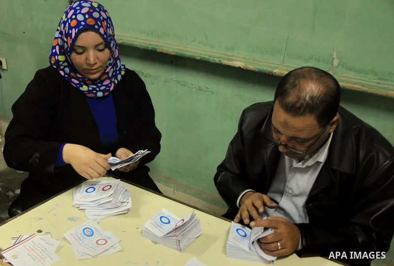 Officials count ballots after polls closed during the final stage of a referendum on Egypt's new constitution in Cairo, January 15, 2014. Polls across Egypt closed on Wednesday evening after a second and final day of vot...
