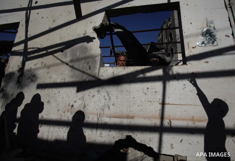 Palestinians inspect their house yard, which they said was hit in an Israeli air strike, in Gaza City January 16, 2014. Israel's Iron Dome missile defence system intercepted five rockets fired at the city of Ashkelon fro...