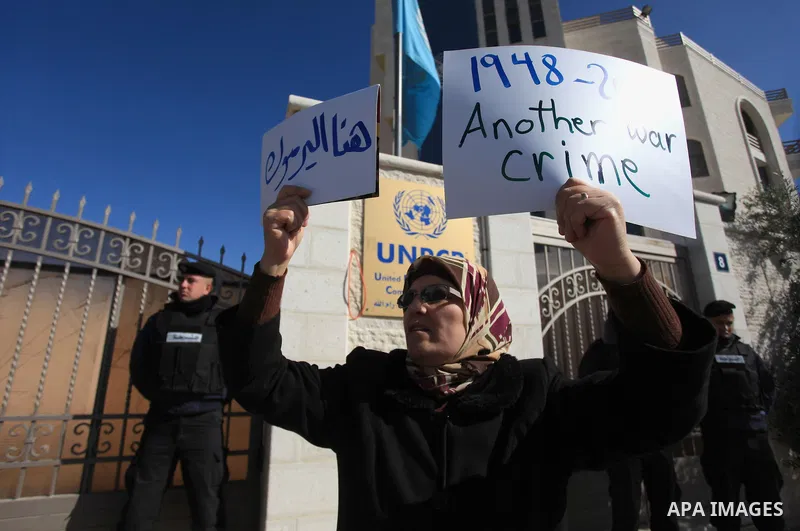 Palestinian women take part in a gathering to show solidarity with Palestinian refugees in Syria's main refugee camp Yarmuk, in front of the headquarters of the United Nations in the West Bank city of Ramallah, on Januar...