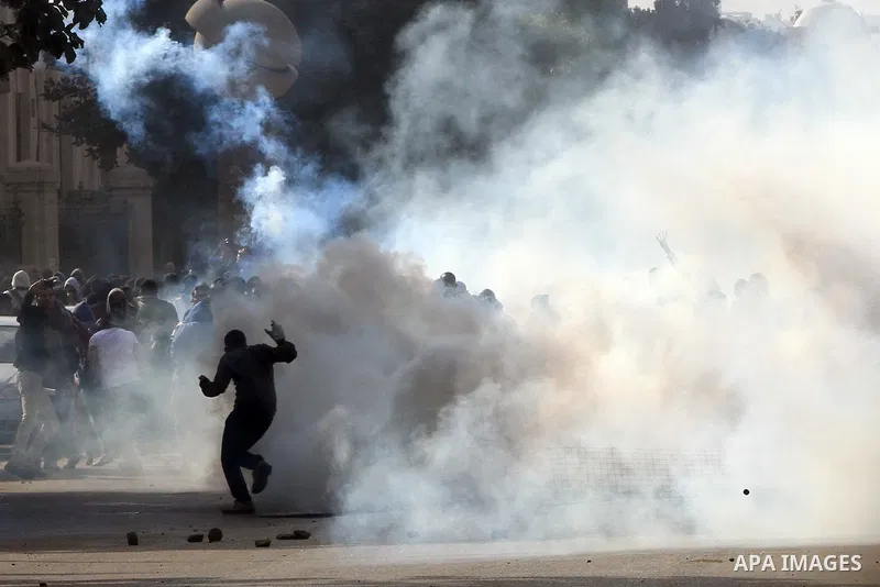 Supporters of Egypt's ousted President Mohammed Morsi clash with security forces near Cairo University in Giza, Egypt, Thursday, Jan. 16, 2014. Egypt's Muslim Brotherhood group and other Islamist groups boycotted the ref...