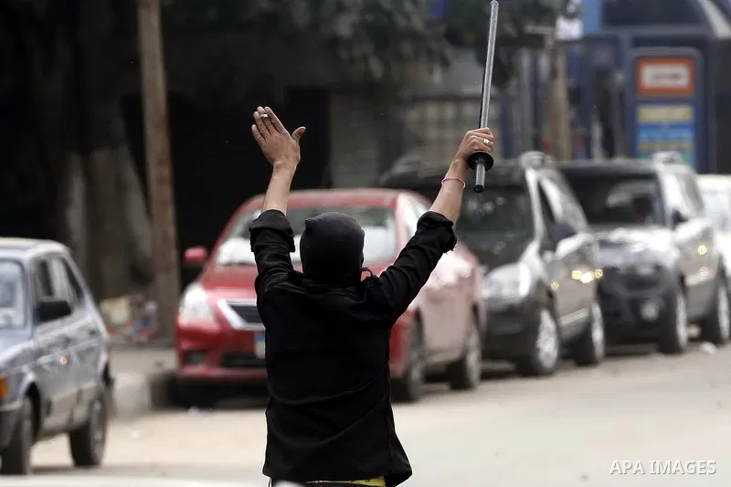 Supporters of Egypt's ousted President Mohammed Morsi clash with security forces near Cairo University in Giza, Egypt, Thursday, Jan. 16, 2014. Egypt's Muslim Brotherhood group and other Islamist groups boycotted the ref...