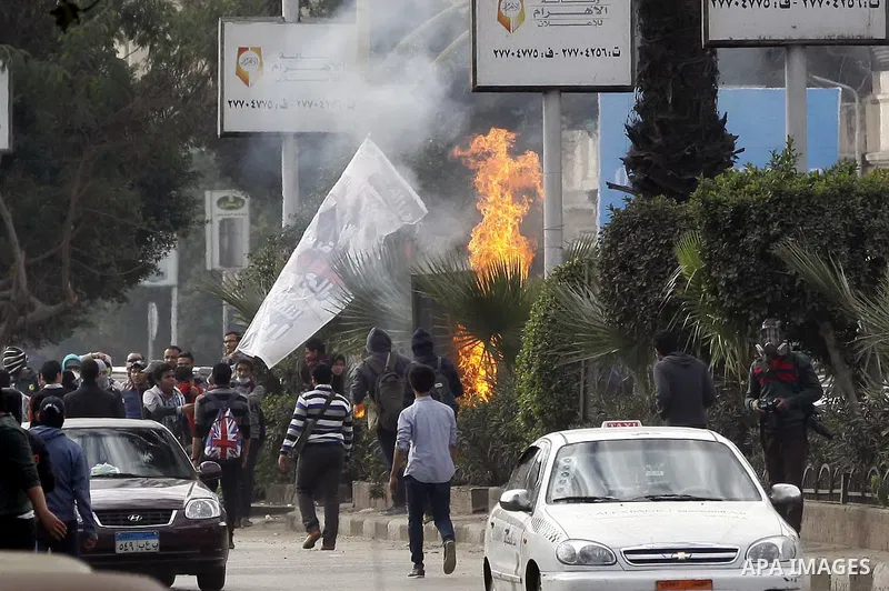 Supporters of Egypt's ousted President Mohammed Morsi clash with security forces near Cairo University in Giza, Egypt, Thursday, Jan. 16, 2014. Egypt's Muslim Brotherhood group and other Islamist groups boycotted the ref...