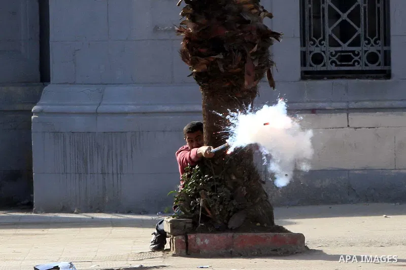 Supporters of Egypt's ousted President Mohammed Morsi clash with security forces near Cairo University in Giza, Egypt, Thursday, Jan. 16, 2014. Egypt's Muslim Brotherhood group and other Islamist groups boycotted the ref...