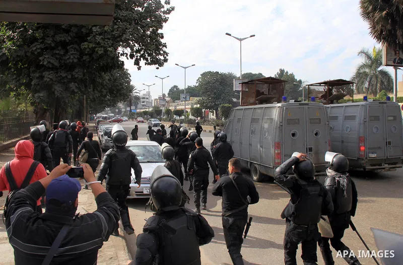 Supporters of Egypt's ousted President Mohammed Morsi clash with security forces near Cairo University in Giza, Egypt, Thursday, Jan. 16, 2014. Egypt's Muslim Brotherhood group and other Islamist groups boycotted the ref...