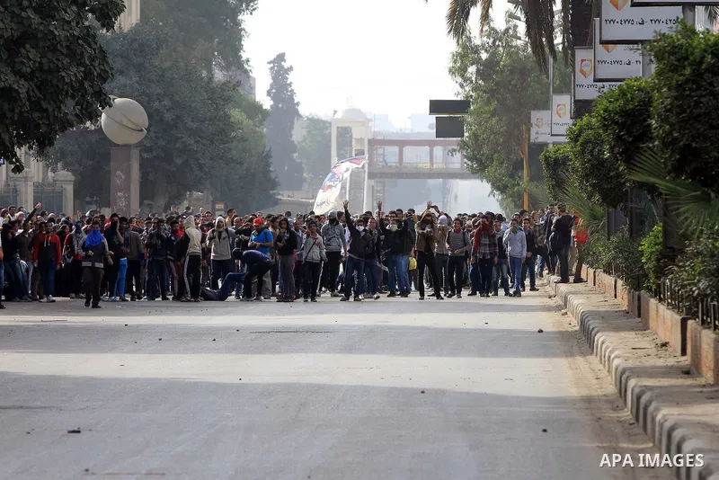 Supporters of Egypt's ousted President Mohammed Morsi clash with security forces near Cairo University in Giza, Egypt, Thursday, Jan. 16, 2014. Egypt's Muslim Brotherhood group and other Islamist groups boycotted the ref...
