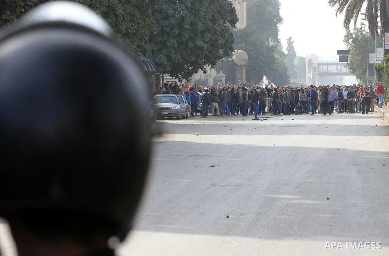 Supporters of Egypt's ousted President Mohammed Morsi clash with security forces near Cairo University in Giza, Egypt, Thursday, Jan. 16, 2014. Egypt's Muslim Brotherhood group and other Islamist groups boycotted the ref...