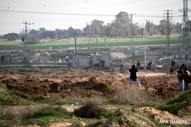Palestinian protesters take part in a demonstration near the Nahal Oz border crossing with Israel, east of Gaza City on January 17, 2014. The Israeli army fired live rounds and tear gas at protesters near the border fenc...